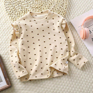 Toddler wearing Feather & Fawn ribbed ruffle long sleeve top