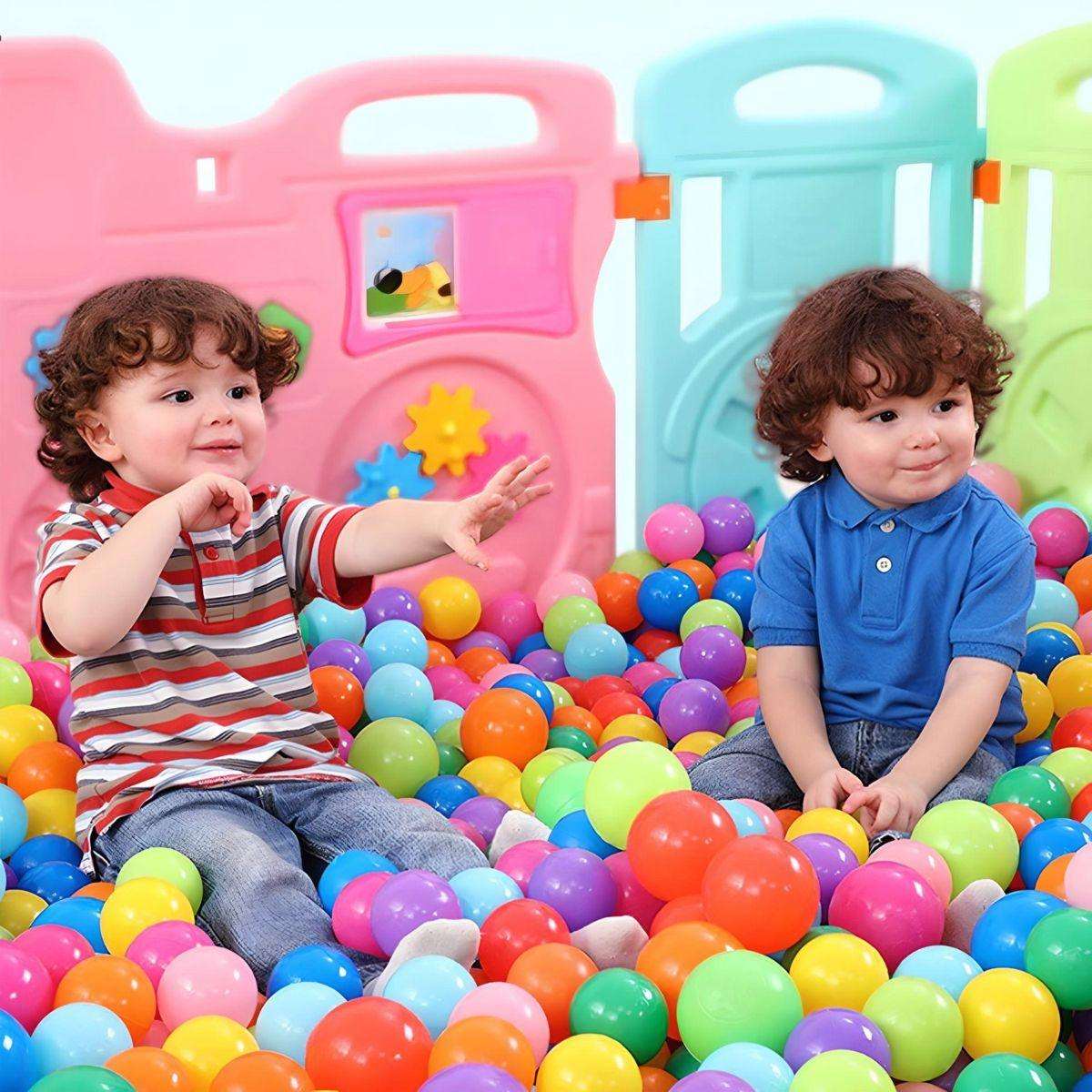 Two toddlers playing in a colorful BabiePlay Colourful Odyssey Ball Pit filled with vibrant, non-toxic plastic balls