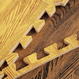 BabiePlay wood grain EVA foam puzzle play mat pieces with interlocking edges on wooden floor
