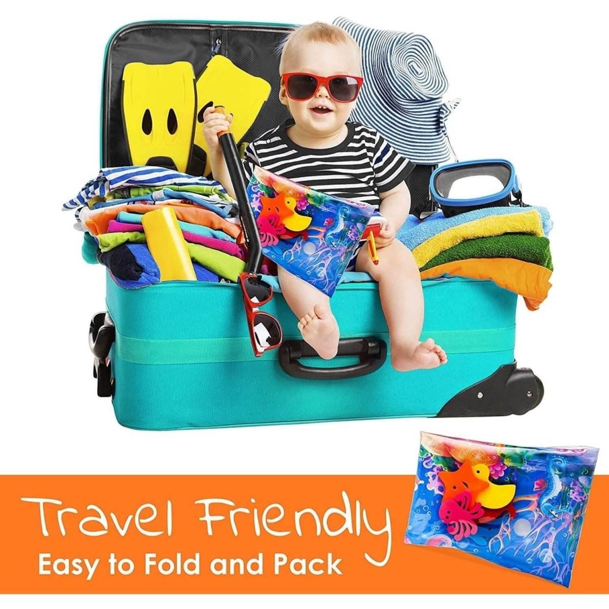 Baby with sunglasses sitting in a packed suitcase holding BabiesMart Tummy Time Water Play Mat, travel-friendly and easy to fold and pack.