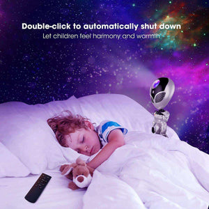 Alien Galaxy Projector night light glowing above sleeping child with starry nebula background and remote control nearby