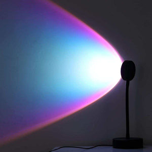 Glowly Sunset Lamp projecting colorful gradient light on wall with soft RGB hues