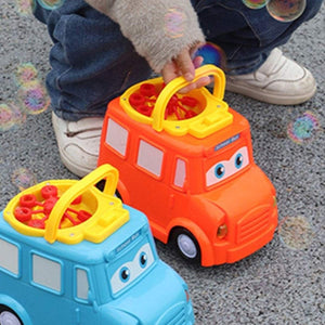 Children playing with colorful school bus bubble blower toys creating bubbles outdoors