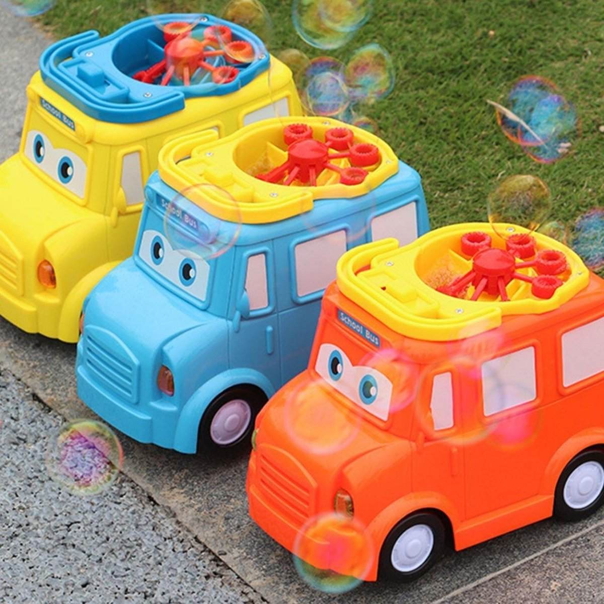 Colorful school bus bubble blower toys creating bubbles outdoors on pavement
