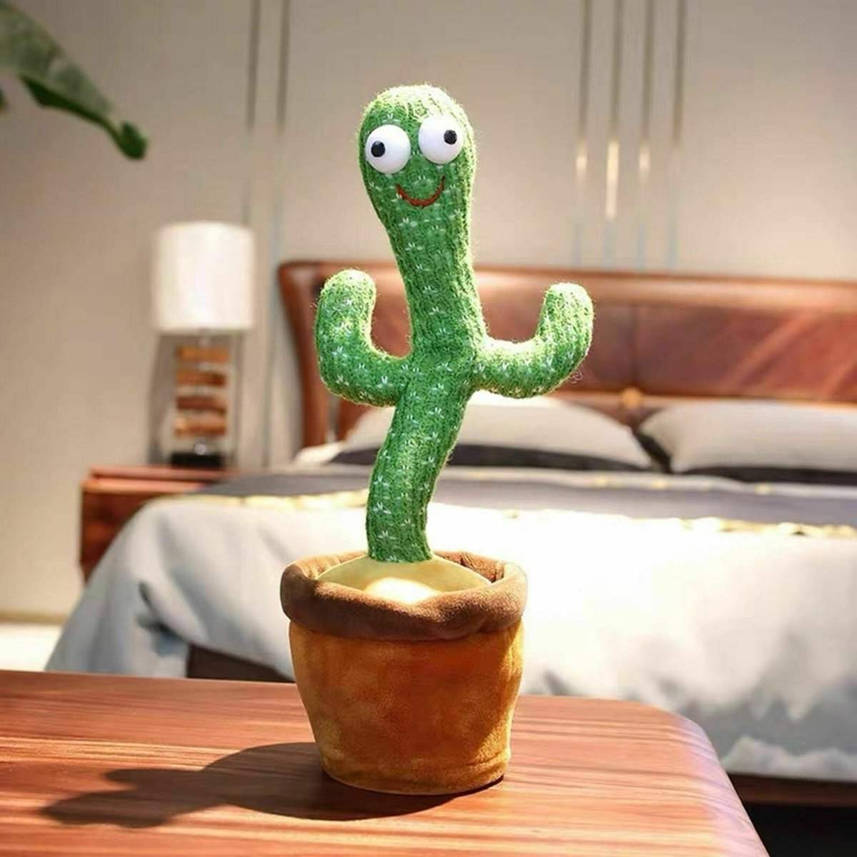 Dancing Cactus Repeat Talking plush toy in a brown pot on a wooden table in a bedroom setting
