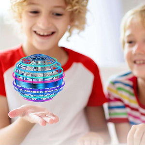 Kidst flying drone hovering orb toy with RGB light held by smiling child