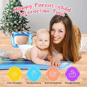 Mother and baby enjoying tummy time on Toddly SplashMirror sensory water mat with mirror and floating animals near Christmas tree