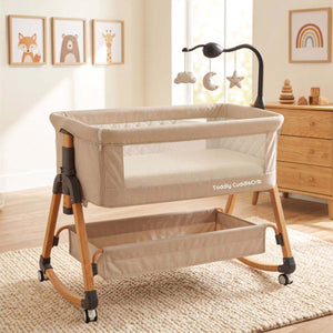 Baby Bassinet & Bedside Co-Sleeper in beige linen-cotton blend with wood-grain powder-coated steel frame, mesh sides, storage basket and mobile rocker design