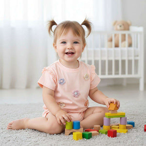 Baby girl wearing Feather & Fawn SweetSummer Daisy cotton tee with 3D crochet daisies